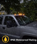 Three Piece Smoked Amber Cab Roof Marker Lights Kit With 30 LED For 2002 To 2007 Chevy Silverado And GMC Sierra Trucks showing lights in rain