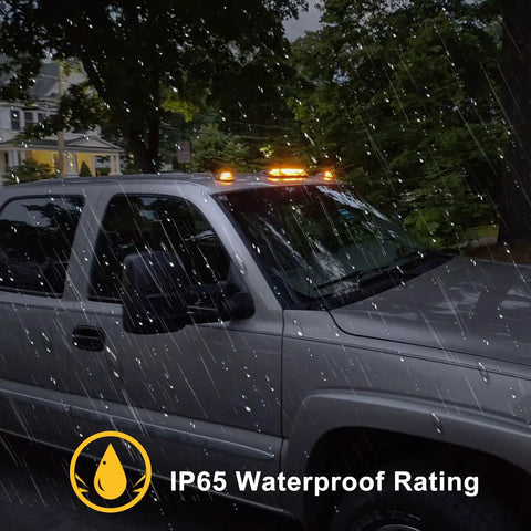 Three Piece Smoked Amber Cab Roof Marker Lights Kit With 30 LED For 2002 To 2007 Chevy Silverado And GMC Sierra Trucks showing lights in rain