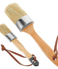 Two Pack Wood Handle Paint Brushes With Pro Grade Synthetic Bristles shown with oval design, leather straps, khaki handles