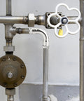 Front view: stainless steel 1-inch 90-degree press elbow in a metal plumbing line with a white-handled gate valve