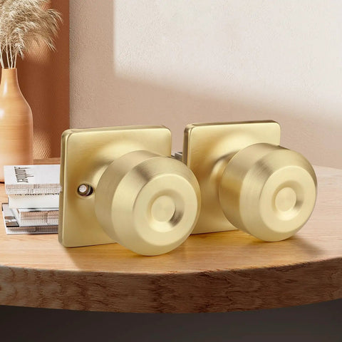 Polished round gold door knobs on wooden table, square backplate. Not Six Piece Polished Chrome Privacy Door Levers Set For Bedroom And Bathroom Interior Doors With Keyless Inside Lock Heavy Duty Modern Door Handles Silver Finish Easy Install.