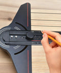 Hand using Pro Grade Layout Measuring Tool With Angles Finder For Woodworking And Construction on wooden surface