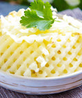 Two-pack stainless steel crinkle cutter set for potatoes; close-up of wavy-cut potato slices with parsley garnish