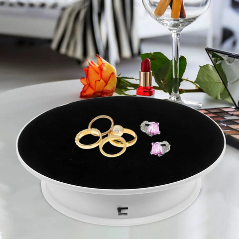 Ultimate 360 Degree Electric Turntable Rotating Display Stand With Two-Speed Adjustment For Jewelry Watches Photoshoot And Commercial Showcase Using White Base And Black Velvet Surface featuring rings and earrings on velvet surface.