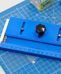 RC Tank Track Link Assembly Jig For Easy Track Link Installation, Portable Chain Wheel Tool on blue cutting mat