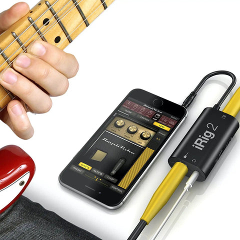 iRig 2 Portable Guitar Interface For iPhone iPad And Mac Lightweight Audio Adapter shown with guitar and connected smartphone.