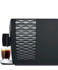 Top Tier Automatic Coffee Maker In Sleek Piano Black With One Touch Brewing For Barista Style Espresso And Creamy Latte Blends Made Daily Without The Sweat, showcasing sleek side design and brewed espresso.