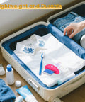 Open suitcase with clothing, toothpaste tube, and Four Pack Toothpaste Squeezers Hanging Tube Squeezer Tool Multicolor Tubular Paste Dispenser