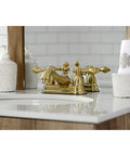Restoration Four Inch Centerset Bathroom Faucet In Brushed Brass With Solid Brass Construction Drip Free Ceramic Disc Deck Mount Centerset Three Hole Installation 1.2 GPM At 60 PSI Classic Vintage Style Victorian Inspired on wooden vanity with white sink