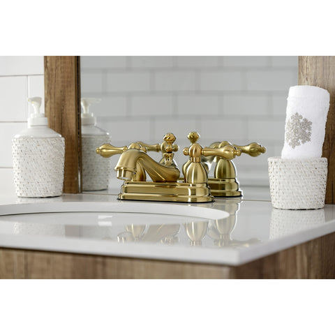 Restoration Four Inch Centerset Bathroom Faucet In Brushed Brass With Solid Brass Construction Drip Free Ceramic Disc Deck Mount Centerset Three Hole Installation 1.2 GPM At 60 PSI Classic Vintage Style Victorian Inspired on wooden vanity with white sink
