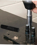 Using the Hydraulic Punch Driver Kit Knockout Tool for electrical conduit and metal sheet punching on a workbench.