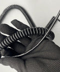 Rock Solid Coiled Power Extension Cord With Spring Wire Cable And Five Core Conductors shown in hand, black coiled design for easy use.