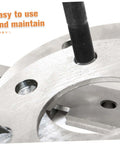 Close-up of hydraulic punch driver kit knockout tool with die, showcasing clean hole punching in metal sheet.
