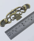 Six Pack Bail Pull Handles For Cabinets, 3.89 Inch Total Length, Zinc Alloy Drawer Pulls with antique bronze design next to ruler