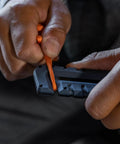 Blue Gerber Prybrid multi-tool with orange lanyard, close-up of grip area.