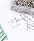 Heavy Duty Stainless Steel Straight Pins 1000 Pack Flat Head Dressmaker Tools on a surface with printed text.