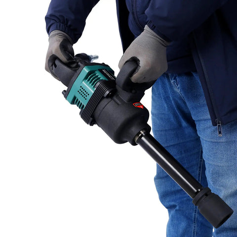 Heavy Duty One Inch Pneumatic Impact Wrench Pumping Out Badass 1900 Ft Lbs Of Raw Torque held by a mechanic wearing gloves.