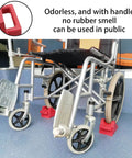 Two Pack Rubber Wheelchair Chocks With Handle For Stable Seating And Slip Proof Easy Grip Wheel Stopper in use under wheelchair