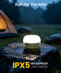 Rechargeable Camping Lantern With 5000mAh Battery glowing on wet rock in rain, IPX5 waterproof for outdoor use