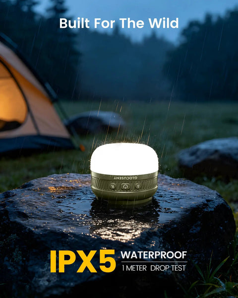 Rechargeable Camping Lantern With 5000mAh Battery glowing on wet rock in rain, IPX5 waterproof for outdoor use