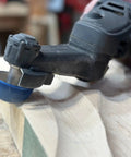 Close-up of Badass Two Inch Tungsten Carbide Contour Wheel For Die Grinders on wood for smooth shaping and material removal.