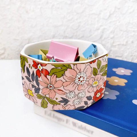 Ceramic Paper Clip Holder With Gold Line Dispenser, Desk Organizer For Paper Clips, floral pattern on desk next to blue book