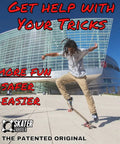 Skateboard Trick Training Wheels To Nail Ollies And Kickflips Faster, skater using training tool outside modern building.