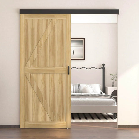 Six Foot Sliding Barn Door Hardware Track Kit With Handles In Black installed above a wooden door in a modern bedroom setting.