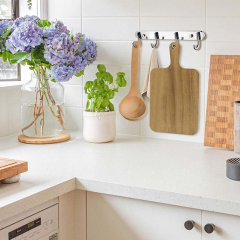 Acacia wood cutting boards set, 15-pack, hanging on kitchen wall hooks.
