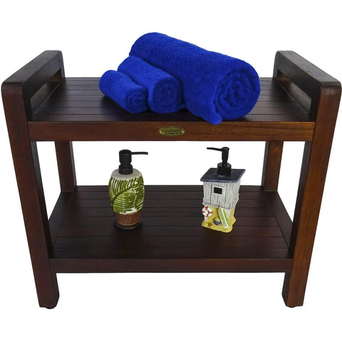 Teak Shower Bench With Shelf And LiftAide Arms For Safe Shower Mobility Adjustable Foot Pads Durable Solid Teak Bath Bathroom Bench With Drainage Slats Brown, view with towels and bottles on shelves.