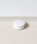 Temperature Sensor 3 Pack For Nest Thermostat Smart Home Sensor That Works With Nest Learning Thermostat And Nest Thermostat E Delivers Precise In Room Readings To Keep Your Space Cozy And Efficient. White round Nest temperature sensor on light wood surface