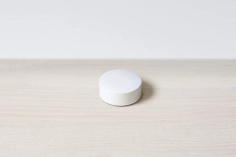 Temperature Sensor 3 Pack For Nest Thermostat Smart Home Sensor That Works With Nest Learning Thermostat And Nest Thermostat E Delivers Precise In Room Readings To Keep Your Space Cozy And Efficient. White round Nest temperature sensor on light wood surface