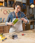 Woman using Top Tier Cordless Pen Engraver And Digital Soldering Iron Kit With Sweet 20V Battery on green bottle.