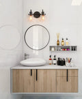 Bathroom with Black 2-Light Vanity Light Fixture With Clear Glass Shades above a round mirror and wooden vanity.