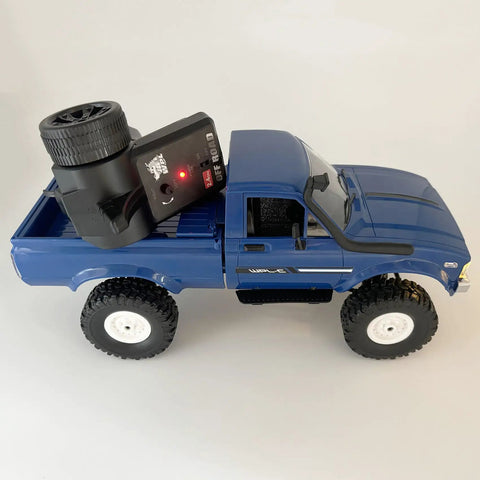 Blue RC Crawler C24 4x4 Off Road Truck RTR 1/16 Scale with Proportional Steering 2.4GHz Radio and LED Lights on white surface