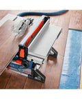 Heavy Hitter 18v Portable Table Saw 8 1/4 Inch Blade Bare Tool with cutting wood on worksite floor.