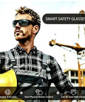 Bluetooth Safety Glasses With Photochromic Lenses And Crisp Clear Audio For The Daily Grind Rechargeable Led Work Eyewear With Twenty Hour Battery Life Tr90 Frame Ansi Certified Smart Audio Sunglasses Built Different worn by a man on a construction site.