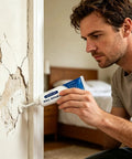 Man applying Easy Diy Drywall Repair Paste For Quick Fixes That Seals Cracks And Holes Tile Grout And Concrete Shower Floor Waterproof Sealant Wall Mending Paste Tube on a wall crack.