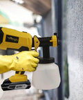 Person using Brushless HVLP Cordless Paint Sprayer 1200ML Cup With 4 Nozzles And 3 Spray Patterns That Works With 20V Batteries