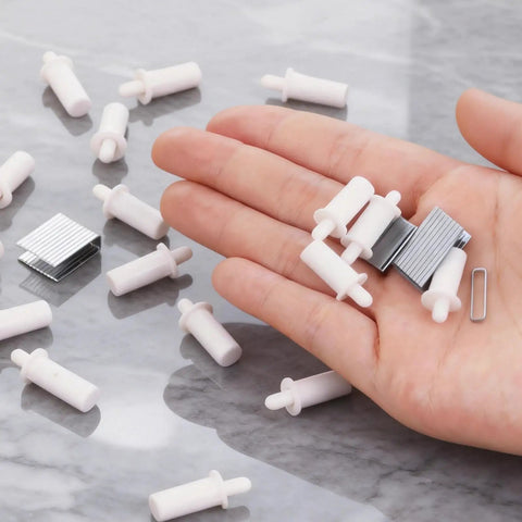 Grab These Bad Boys To Fix Slipped Plantation Shutters In No Time With This Top Shelf Repair Kit Packing Heavy Duty Pins And Smooth Crimp Staples For A Solid Fit That Holds Up Forever - white pivot pins and smooth crimp staples displayed on a hand.