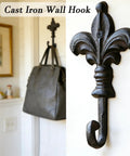 Top Shelf Single Piece Heavy Duty Cast Iron Wall Hook With Screws Vintage Coat Hanger Organizer For Scarves Bags Towels Keys Cap Rustproof Badass Home Decor Accessory mounted on wall holding a bag.