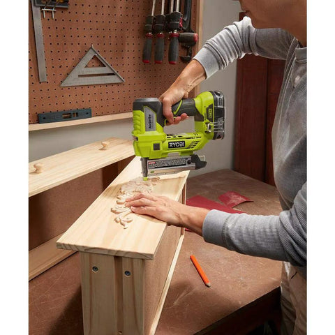 Person using Cordless AirStrike 23-Gauge Pin Nailer, 18-Volt One Plus, Headless Pin Nailing on wooden cabinet piece