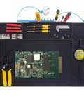 Top view of Silicone Soldering Mat With Stand, 20x14 Inch ESD Safe Anti Static Workbench Pad with tools and PCB assembly.