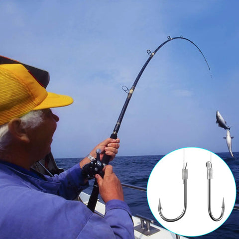 Angler fishing on ocean with rod; inset showing two large fish hooks, suitable for various bait types in deep sea fishing.