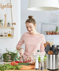 Woman slicing vegetables in kitchen with Extra Large Stainless Steel Rotating Utensil Holder For Countertop visible