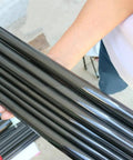 Person holding Two Pack 3K Carbon Fiber Tube 24x20mm 24x22mm 24.29x23mm 500mm Length Pro Grade Lightweight Beefy Strength