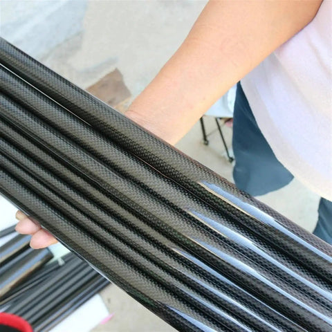 Person holding Two Pack 3K Carbon Fiber Tube 24x20mm 24x22mm 24.29x23mm 500mm Length Pro Grade Lightweight Beefy Strength