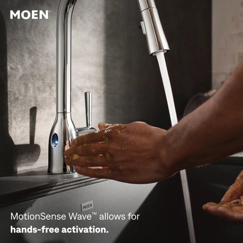Moen Swyre Pulldown Kitchen Faucet, Chrome, 87508EW with hands demonstrating hands-free activation feature.