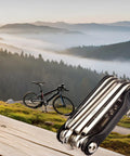 All In One Carbon Steel Bike Multi Tool For Road And Mountain Bikes With 12 Precision Tools Including Chain Breaker Tire Repair Kit Hex Wrenches Torx Screwdrivers Flat Head And Non Slip Grips in a scenic mountain setting