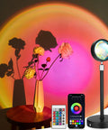 Sunset Lamp Projection With Remote And Phone App Control RGB Color Changing LED Night Light projecting colorful light onto roses
